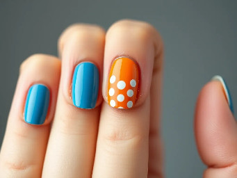 Sea blue and orange alternating nails. Blue ring finger with white polkadot