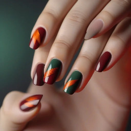a very simple fall nail art design with the colours dark red, a normal red, dusty orange and dark-ish green