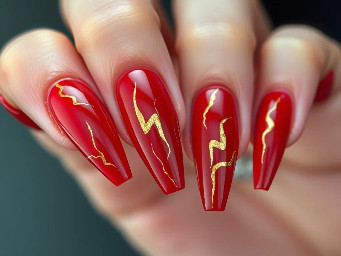 extra long redc nails with gold lightning shapes on them