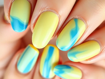 Women’s almond shape nails in yellow and different shades of blue in a simple water pool look.